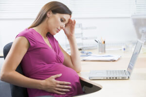 pregnant woman at work who is tired